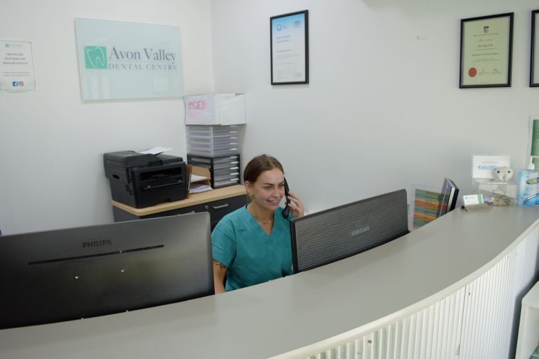 answering phone at reception of avon valley dental centre