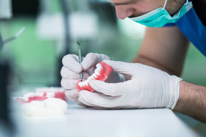 dentist working on a pair of new dentures